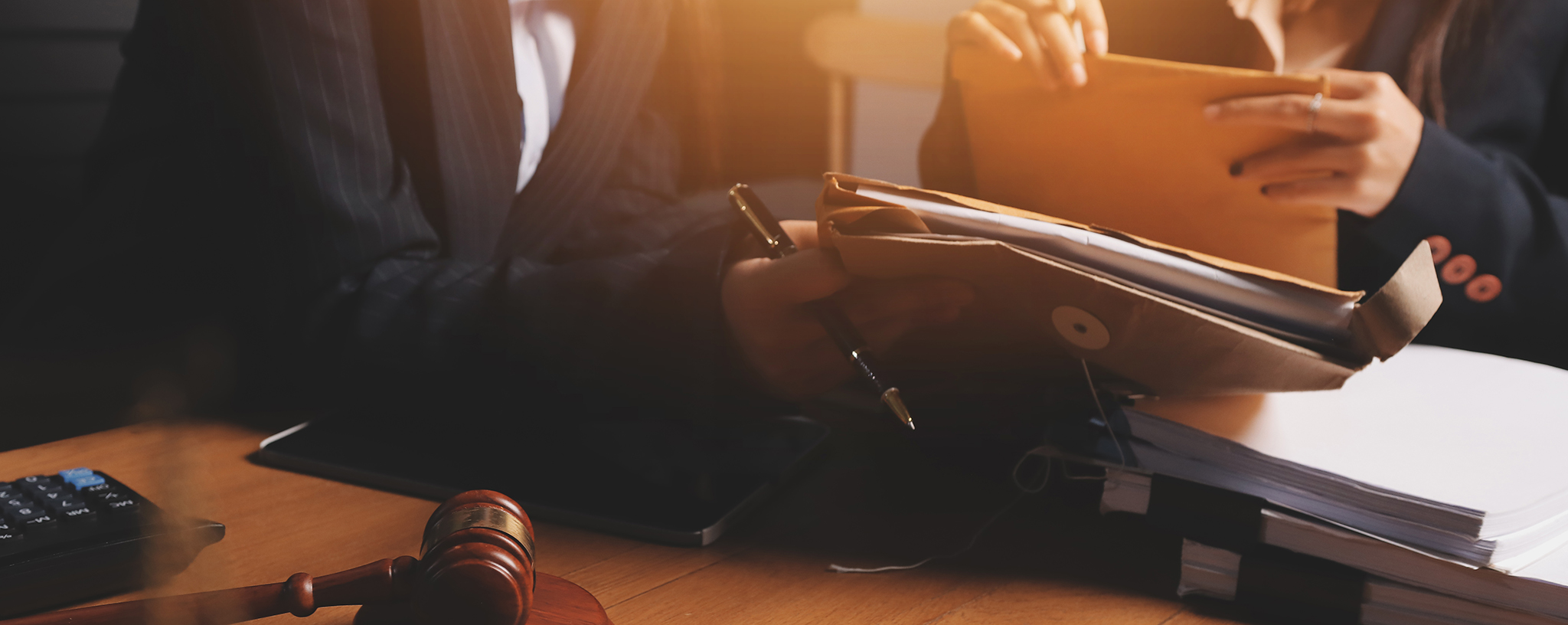 Attractive young lawyer in office Business woman and lawyers discussing contract papers with brass scale on wooden desk in office. Law, legal services, advice, Justice and real estate concept.